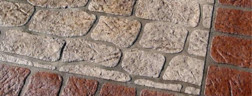 Tan Antique Colonial concrete overlay with irregular textured stone shapes, gray joints, and a reddish-brown brick border.