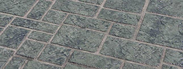 Gray Ashlar Tile concrete overlay with textured square and rectangular tile shapes of varying sizes separated by light brown joints.
