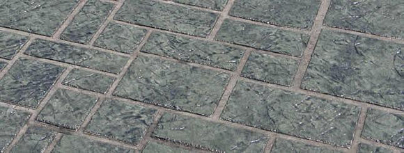 Gray Ashlar Tile concrete overlay with textured square and rectangular tile shapes of varying sizes separated by light brown joints.