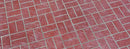 Red Basket Weave concrete overlay with pairs of textured brick shapes alternating horizontally and vertically, separated by gray joints.