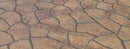 Tan and brown Bushrock concrete overlay with irregular textured rock shapes separated by dark gray joints.