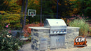 CEM Kraft gray stone-look outdoor kitchen island with light countertop, built-in grill, double access doors, and drawers