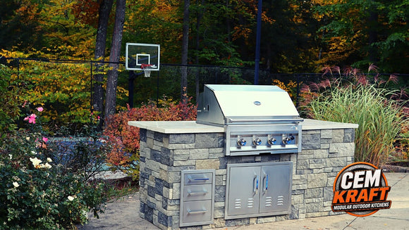 CEM Kraft gray stone-look outdoor kitchen island with light countertop, built-in grill, double access doors, and drawers