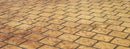 Tan cobble stone pattern concrete overlay with rounded rectangular stone shapes in staggered rows and dark joint lines