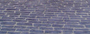 Gray English Cobble concrete overlay with elongated irregular stone shapes in staggered rows and light joint lines