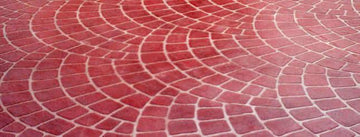 Red European Fan concrete overlay with overlapping curved brick patterns and light-colored joint lines