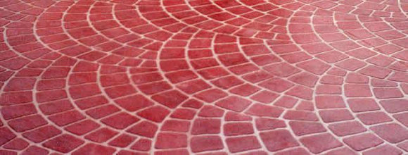 Red European Fan concrete overlay with overlapping curved brick patterns and light-colored joint lines