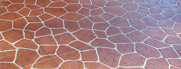 Reddish-brown flagstone-pattern concrete overlay with irregular stone shapes and light grout lines